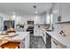 Modern kitchen featuring white cabinets, stainless steel appliances, and a large island with breakfast bar at 236 Barfield Sw Ave, Atlanta, GA 30310