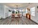 Open-concept kitchen and dining area with stainless steel appliances and modern lighting fixtures at 236 Barfield Sw Ave, Atlanta, GA 30310