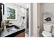 Modern bathroom with double sink vanity and walk-in shower featuring a marble accent wall at 4617 Cedar Park Dr, Stone Mountain, GA 30083