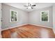 Spacious bedroom featuring hardwood floors, two windows, and neutral paint at 4617 Cedar Park Dr, Stone Mountain, GA 30083