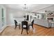 Open-concept dining area with hardwood floors, natural light, and access to kitchen at 4617 Cedar Park Dr, Stone Mountain, GA 30083