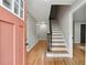 Inviting entryway with a staircase, hardwood floors, and a brightly colored front door at 4617 Cedar Park Dr, Stone Mountain, GA 30083
