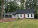 Charming single-story home with a two-car garage, orange front door, and a well-maintained lawn with mature trees at 4617 Cedar Park Dr, Stone Mountain, GA 30083