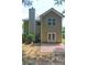 Back exterior featuring a brick patio and door with glass at 112 Lexington Parke Dr, Woodstock, GA 30189