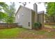 Backyard featuring a small brick patio, lawn, and wood fence at 112 Lexington Parke Dr, Woodstock, GA 30189