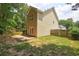 Backyard featuring a small brick patio, lawn, and wood fence at 112 Lexington Parke Dr, Woodstock, GA 30189