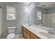Bright bathroom featuring a double vanity, window, and tile flooring at 112 Lexington Parke Dr, Woodstock, GA 30189