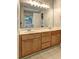 Bathroom featuring double sink vanity with wood cabinets at 112 Lexington Parke Dr, Woodstock, GA 30189