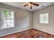 Bedroom features hardwood flooring, ceiling fan and natural light at 112 Lexington Parke Dr, Woodstock, GA 30189