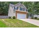 Charming two-story home featuring a two-car garage, stone accents, and a well-manicured lawn at 112 Lexington Parke Dr, Woodstock, GA 30189