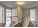 Upstairs hallway with hardwood flooring and open doors at 112 Lexington Parke Dr, Woodstock, GA 30189