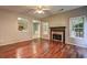 Cozy living room featuring hardwood floors, a fireplace, and lots of natural light at 112 Lexington Parke Dr, Woodstock, GA 30189