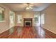Cozy living room featuring hardwood floors, a fireplace, and lots of natural light at 112 Lexington Parke Dr, Woodstock, GA 30189