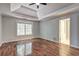 Spacious main bedroom features a tray ceiling, large window, and hardwood floors at 112 Lexington Parke Dr, Woodstock, GA 30189