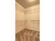 Walk-in closet with shelves and neutral carpet at 112 Lexington Parke Dr, Woodstock, GA 30189