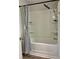 Bathroom shower and tub combination with chrome shower head and curtain at 1743 Moss Dr, Snellville, GA 30078