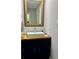 Bathroom vanity with wood countertop, vessel sink, wooden framed mirror, and chrome water faucet at 1743 Moss Dr, Snellville, GA 30078