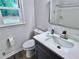 Modern bathroom featuring sleek vanity with a white countertop, complemented by a toilet and a shower over tub at 1743 Moss Dr, Snellville, GA 30078