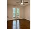 Cozy bedroom with hardwood floors, ceiling fan, and a bright window offering a pleasant view at 1743 Moss Dr, Snellville, GA 30078