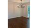 Classic dining room with hardwood floors, modern chandelier, and natural light from a large window at 1743 Moss Dr, Snellville, GA 30078