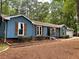 Stylish blue home with well-maintained landscaping, wood shutters and a two-car garage at 1743 Moss Dr, Snellville, GA 30078