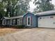 Charming home boasts an attached garage, complemented by dark wood shutters and a well manicured front yard at 1743 Moss Dr, Snellville, GA 30078