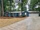 Charming single-story home boasts a lush green landscape, complemented by a spacious driveway and an attached garage at 1743 Moss Dr, Snellville, GA 30078