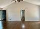 Spacious living room with dark hardwood floors, vaulted ceilings, and a door leading to the backyard at 1743 Moss Dr, Snellville, GA 30078