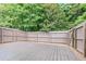Spacious backyard deck overlooks a lush green landscape with a privacy fence surrounding the property at 257 Ridge Mill Dr, Acworth, GA 30102