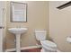 Traditional powder room with pedestal sink, classic mirror, and a standard toilet at 257 Ridge Mill Dr, Acworth, GA 30102