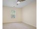 Bedroom features a ceiling fan, neutral walls, plush carpet, and a window with blinds at 257 Ridge Mill Dr, Acworth, GA 30102
