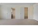 Spacious bedroom with neutral walls and carpet leading to a bathroom and closet at 257 Ridge Mill Dr, Acworth, GA 30102