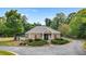 Exterior view of the community clubhouse amidst manicured landscaping, bushes, and trees on a sunny day at 257 Ridge Mill Dr, Acworth, GA 30102