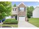 Charming townhome features a stone facade and a one-car garage with a well-manicured lawn at 257 Ridge Mill Dr, Acworth, GA 30102