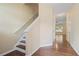 Hallway featuring hardwood floors, a staircase, and views into other rooms, creating an open feel at 257 Ridge Mill Dr, Acworth, GA 30102