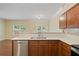 Bright kitchen boasts light countertops, wood cabinets and stainless steel dishwasher at 257 Ridge Mill Dr, Acworth, GA 30102