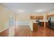 Open-concept kitchen features stainless steel appliances, hardwood floors, and a breakfast bar at 257 Ridge Mill Dr, Acworth, GA 30102