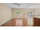 Spacious living room with hardwood floors, a ceiling fan, and a doorway to the outside patio at 257 Ridge Mill Dr, Acworth, GA 30102