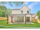Backyard featuring a covered patio with brick accents and a spacious lawn perfect for outdoor entertaining at 504 Barrington Drive, Roswell, GA 30075