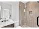 Modern bathroom featuring a glass-enclosed shower, marble tile, and sleek fixtures at 504 Barrington Drive, Roswell, GA 30075