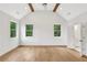 Bright bedroom with hardwood floors, vaulted ceilings, and modern ceiling fan at 504 Barrington Drive, Roswell, GA 30075