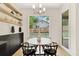 Charming breakfast nook featuring hardwood floors, floating shelves, and a view of the backyard at 504 Barrington Drive, Roswell, GA 30075