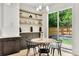 Cozy dining area with open shelving, backyard views, and a stylish chandelier at 504 Barrington Drive, Roswell, GA 30075