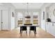Bright dining room with modern light fixture, large windows, and sleek cabinetry at 504 Barrington Drive, Roswell, GA 30075