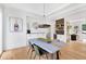 Chic dining room with stylish lighting, modern art, and an adjacent butler's pantry at 504 Barrington Drive, Roswell, GA 30075