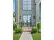 Elegant entryway featuring a modern glass door, brick steps, and manicured shrubbery at 504 Barrington Drive, Roswell, GA 30075
