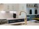 Close-up of the kitchen with premium counter tops and golden plumbing fixtures at 504 Barrington Drive, Roswell, GA 30075