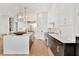 This spacious kitchen features an island, stainless steel appliances, and custom lighting fixtures at 504 Barrington Drive, Roswell, GA 30075