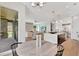 Open-concept living space with a kitchen island, stone fireplace, and seamless indoor-outdoor flow at 504 Barrington Drive, Roswell, GA 30075