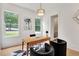 Stylish office featuring a wood desk, sleek chairs, geometric rug and two large windows at 504 Barrington Drive, Roswell, GA 30075